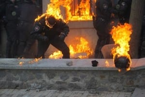 Ukrainian police being attacked by protester’s fire bombs.